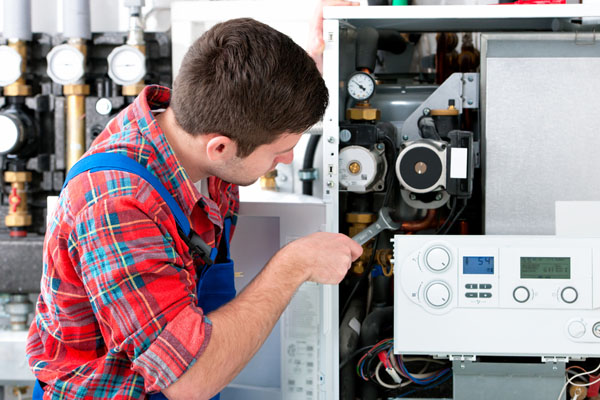 Heating technician repairing boiler controls in Citrus Heights