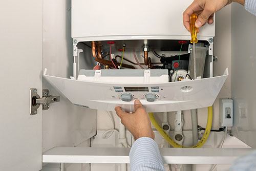 Heating technician repairing a residential boiler in Citrus Heights