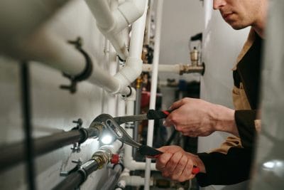 Technician inspecting commercial plumbing pipes in Citrus Heights