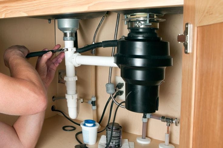 Plumber repairing a garbage disposal in Citrus Heights