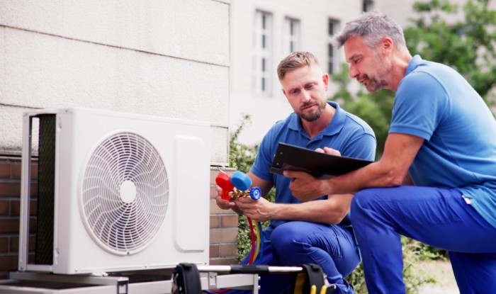 HVAC technicians installing an outdoor air conditioning unit in Citrus Heights